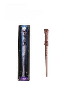Deep brown toy magic wand with light and sound effects in retail blister card packaging