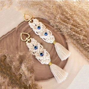 Handmade bohemian keychain with beige cotton macrame, blue evil eye beads and gold clasp