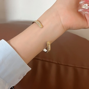 18K gold plated two-tone open bangle with zircon featuring beaded edges and brushed texture