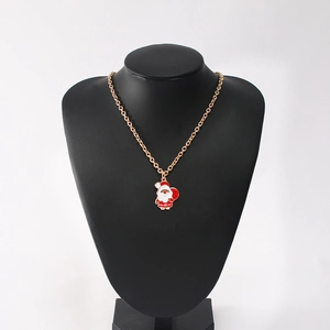 Golden necklace with red and white enamel Santa Claus pendant on a black neck display