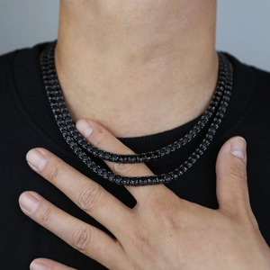 Detail view of double black tennis necklaces with 5mm cubic zirconia on male model