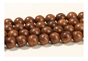 Macro detail of polished rosewood beads with natural wood grain for DIY jewelry making