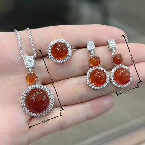 Detail view of jadeite jewelry set with specific size dimensions on model hand