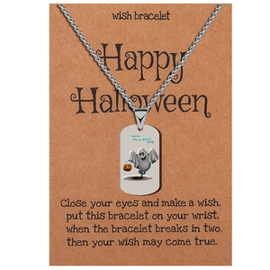 Detail of Halloween ghost and pumpkin pendant on a wish card with stainless steel chain
