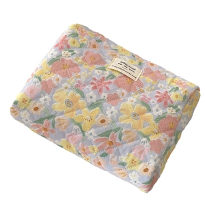 Quilted floral makeup bag in light blue cotton fabric with spacious interior storage