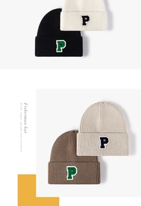 Detail of ribbed knit beanies with P letter patch in black, white, coffee, and beige