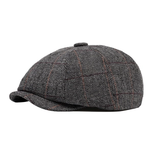 Classic herringbone newsboy cap in dark grey wool tweed with subtle red windowpane pattern