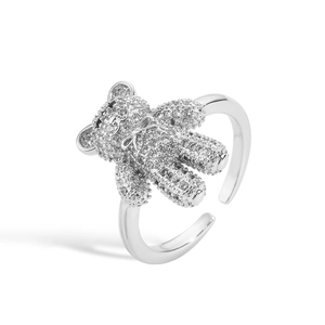 Macro detail of silver bear ring featuring pavé cubic zirconia and 3D bow design