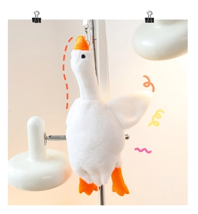 Detailed view of plush white goose toy with soft texture and orange beak and feet