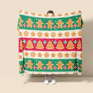 Detailed pattern of festive flannel blanket with gingerbread men and Christmas trees