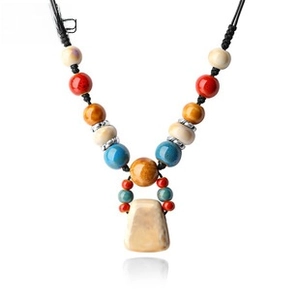 Detailed view of the multi-color beaded necklace with a beige trapezoid pendant