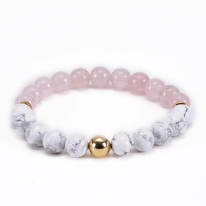 Detail of pink crystal and white marble beads with a gold spherical accent bead