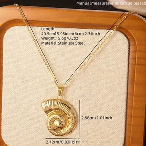 Macro detail of gold stainless steel nautilus shell pendant necklace with size measurements