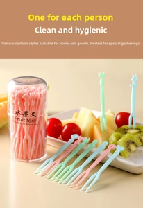 Close-up of pastel cartoon fruit forks set with double tines in transparent storage cup