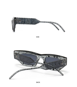 Side and back view of cat eye sunglasses with grey ink marble texture and wide temples
