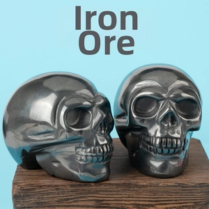 Macro shot of hand-carved natural iron ore skull ornaments with metallic luster