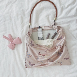 Detail view of pink butterfly print tote bag showing inner pocket and magnetic buckle closure