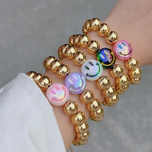 Five-piece 18k gold plated beaded bracelet set featuring colorful smiley face charms