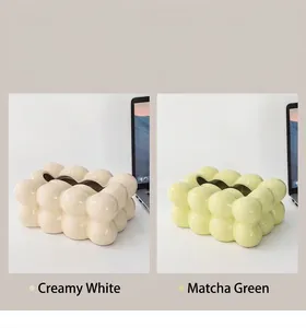 Close-up of marshmallow style ceramic tissue box in cream white and matcha green colors