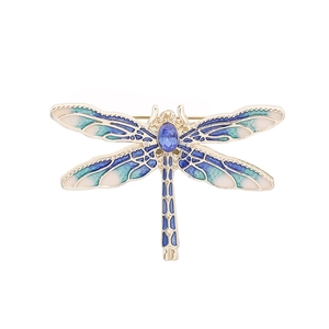 Macro detail of a dragonfly brooch with blue enamel wings and sparkling blue rhinestones