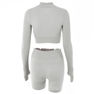 Rear view of light gray ribbed knit two-piece set with cropped top and high waist shorts