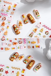 Detail showing 3D relief Christmas nail stickers with gingerbread and festive patterns