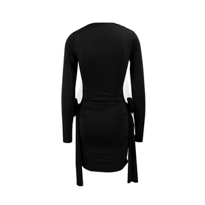 Detail view of the back of a slim-fit black long-sleeve dress with side tie-up accents