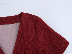 Detailed view of the shoulder and tweed fabric texture on this red blazer dress