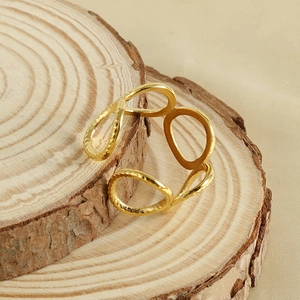 Minimalist 18k gold plated stainless steel open geometric ring on a wooden display