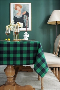 Close-up of green and black plaid cotton linen tablecloth on a rustic wooden table
