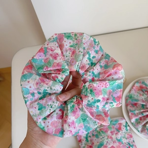 Macro shot of a pink floral oversized scrunchie made of breathable cotton fabric