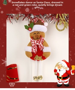 Detail of gingerbread reindeer ornament with Christmas hat, scarf, and golden bells