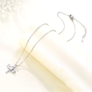 Detailed view of silver dragonfly pendant with sparkling marquise-cut zircons on a chain