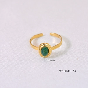 Detail shot of a gold stainless steel ring with a 10mm oval green natural stone inlay