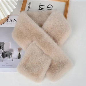 Close-up of fluffy faux mink fur scarf in beige gold with soft plush texture details
