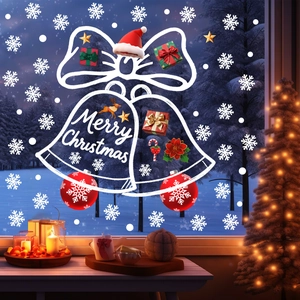 Close-up of Christmas window stickers with white bells and snowflakes on glass