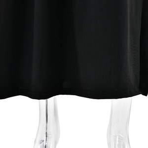 Detail of the high slit hem on a black square neck dress showing fabric texture and cut