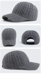 Detail view of dark grey knitted baseball cap with cable knit pattern and back strap buckle