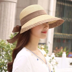 Women's summer straw sun hat with two-tone patchwork design and elegant brown bow ribbon