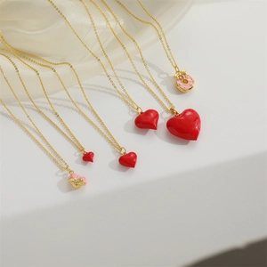 Fashionable gold chain necklace set with red enamel heart and sweet donut pendants