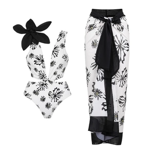 Detail of floral one-piece swimsuit with 3D flower accent and matching long sarong set