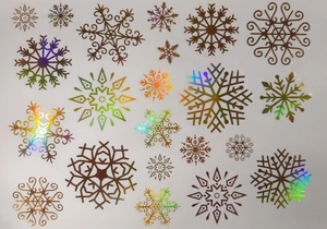 Detail showing 19 various laser gold snowflake static window decals on white backing paper