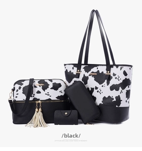 Detail of 4-piece set including cow print tote, crossbody bag, wallet and card holder