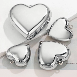 Set of four polished silver heart-shaped pendants in various sizes for jewelry DIY