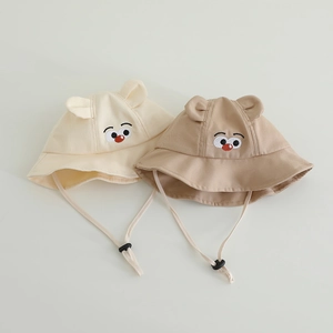 Detail of baby sun hats featuring cute cartoon embroidery and adjustable chin straps