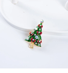 Detail of Christmas tree brooch with green enamel, red bows and crystal rhinestones