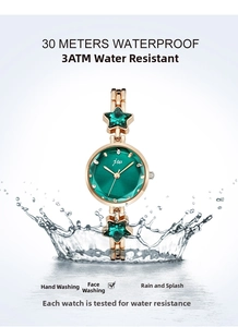 Close-up of waterproof gold starfish watch with green dial and 30M water resistance
