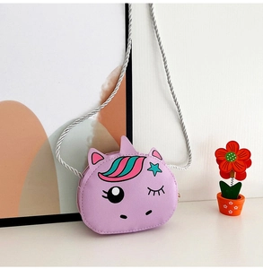Close-up of cute purple unicorn crossbody bag with colorful mane and braided strap