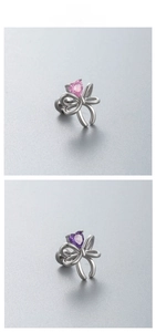 Macro detail of bow-shaped stud earrings with pink and purple heart-cut zircons