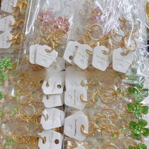 Detail view of colorful rhinestone clover keychains with gold plating and card packaging